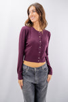 Golfino cropped con bottoni gioiello